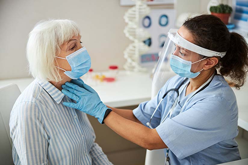 A pediatric nurse in a white coat and mask uses a stethoscope to listen to a young girl's heart, who looks at her with trust and curiosity during a medical check-up in a clinic. A pediatric nurse in a white coat and mask uses a stethoscope to listen to a young girl's heart, who looks at her with trust and curiosity during a medical check-up in a clinic.