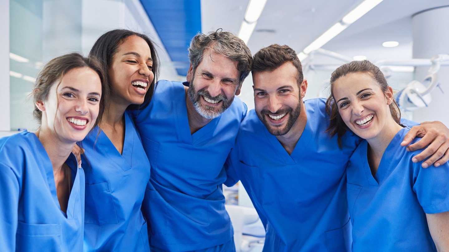 Group of nurses stood together and smiling LargeImage-ANAIS-47.jpg